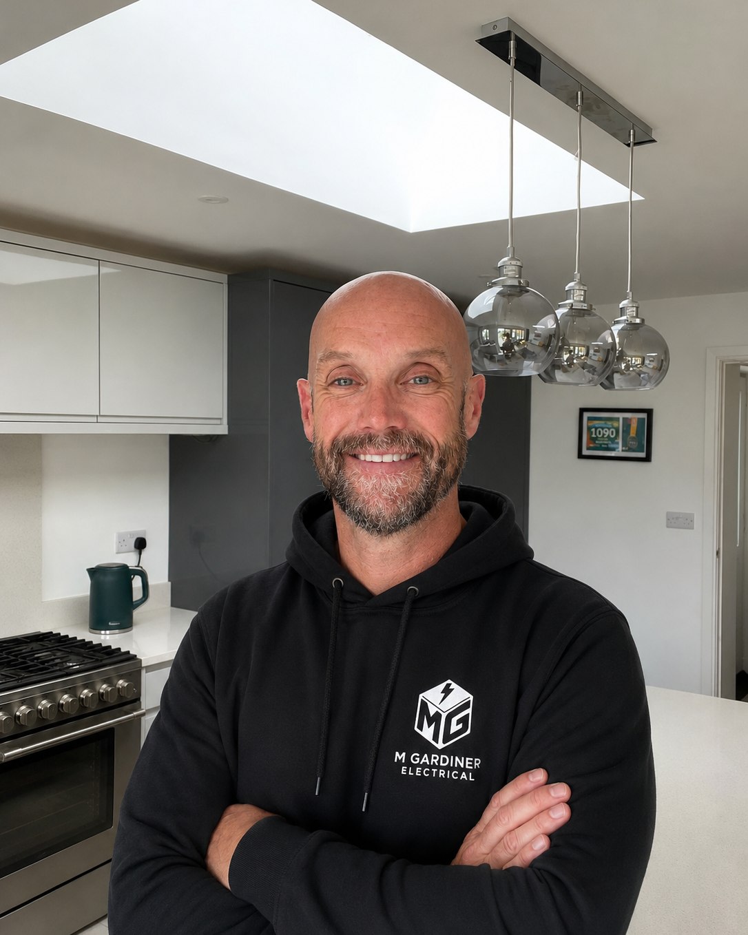 Mike from M Gardiner Electrical standing in a kitchen